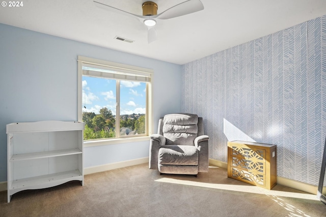 sitting room with carpet and ceiling fan