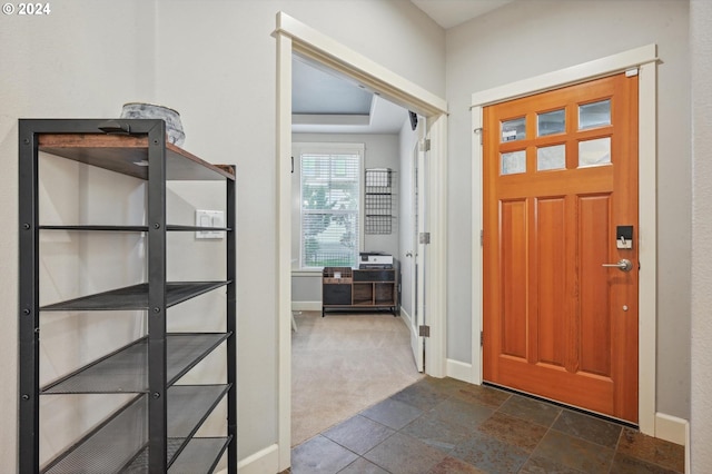 foyer entrance with dark colored carpet