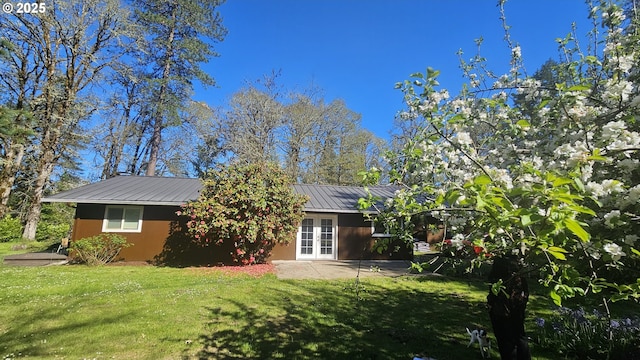 24221 Warthen Rd, Elmira, OR 97437 - rear view of house featuring french doors, a yard, and metal roof