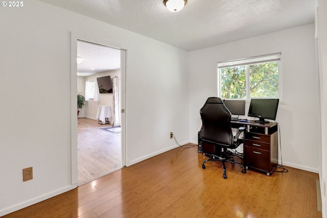 office with wood finished floors and baseboards
