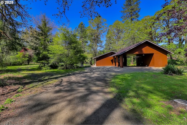 view of front of property with driveway and a carport