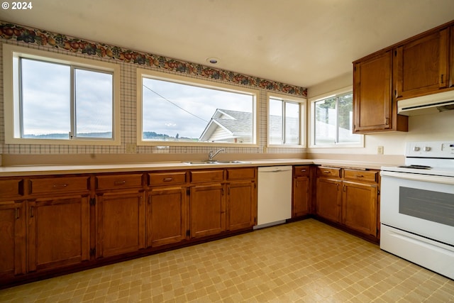 kitchen featuring white appliances and sink