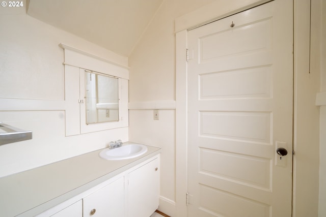 bathroom with vanity and vaulted ceiling