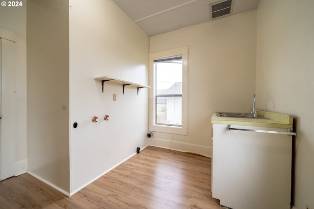 laundry area with hookup for an electric dryer, light hardwood / wood-style floors, sink, and hookup for a washing machine