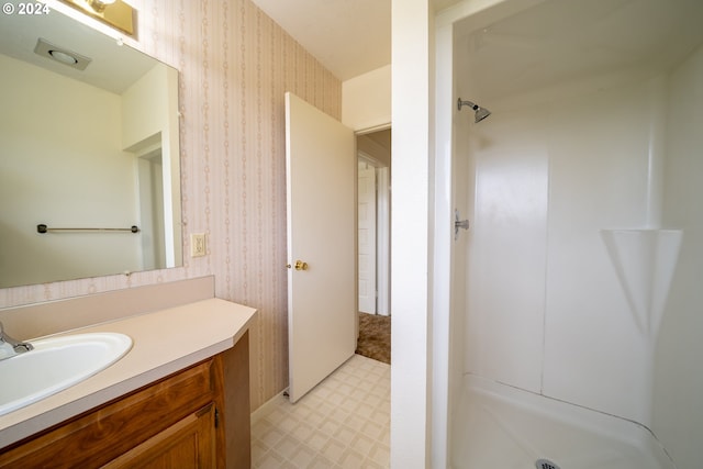 bathroom with vanity and walk in shower