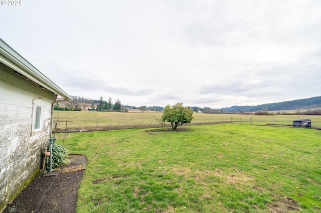 view of yard with a rural view