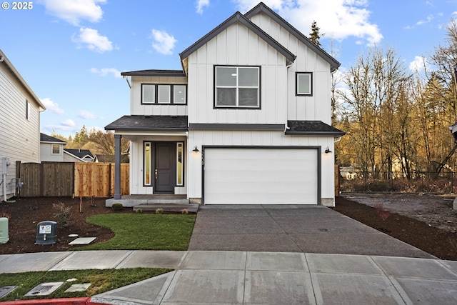 modern inspired farmhouse with an attached garage, a shingled roof, fence, concrete driveway, and board and batten siding