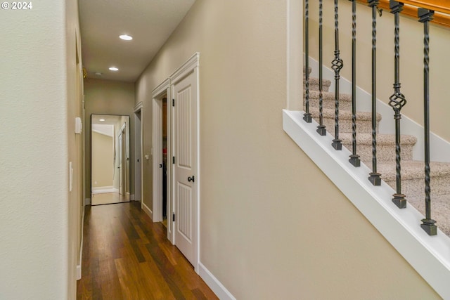 hallway with dark hardwood / wood-style flooring