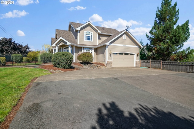 view of front facade featuring a front yard and a garage