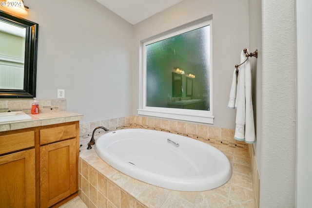 bathroom featuring vanity and a relaxing tiled tub