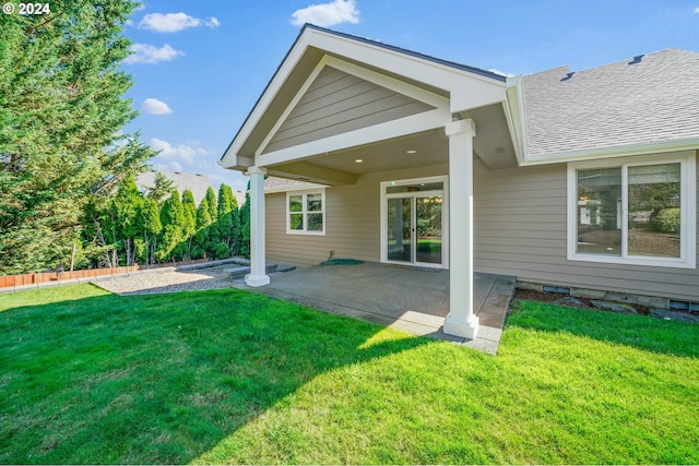 back of property featuring a patio area and a yard