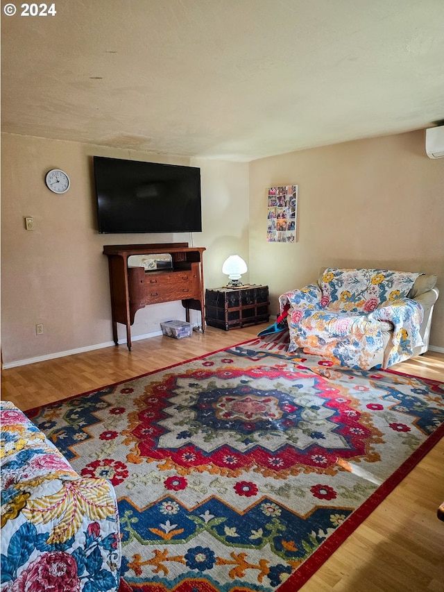 living room with wood-type flooring and a wall mounted air conditioner