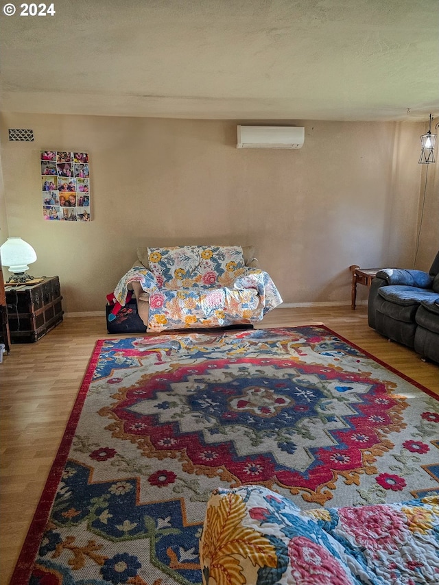 interior space featuring an AC wall unit and hardwood / wood-style flooring