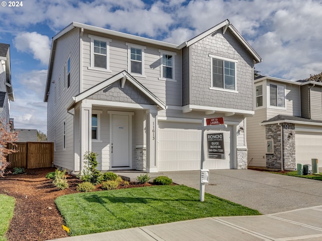 craftsman-style house featuring a garage and a front yard