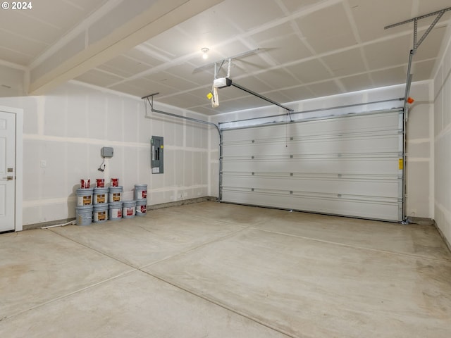 garage with a garage door opener and electric panel