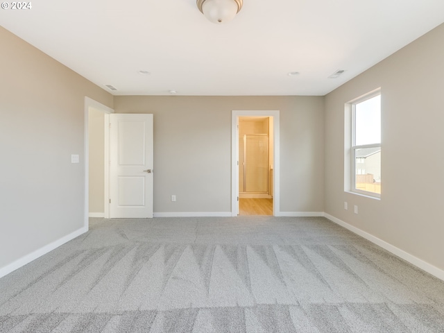 empty room featuring light colored carpet