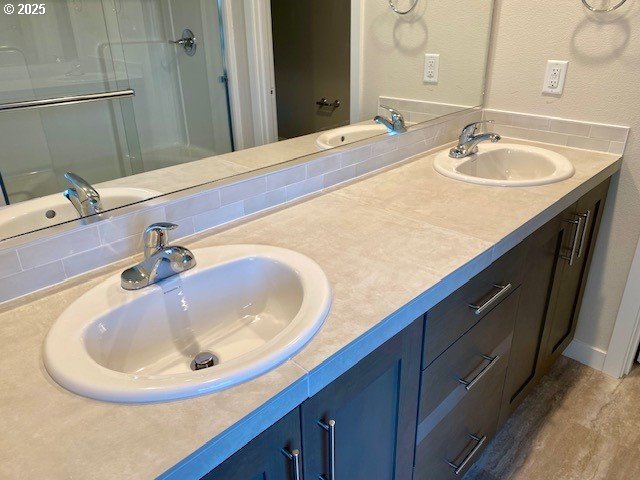 bathroom with hardwood / wood-style flooring, vanity, and a shower with shower door