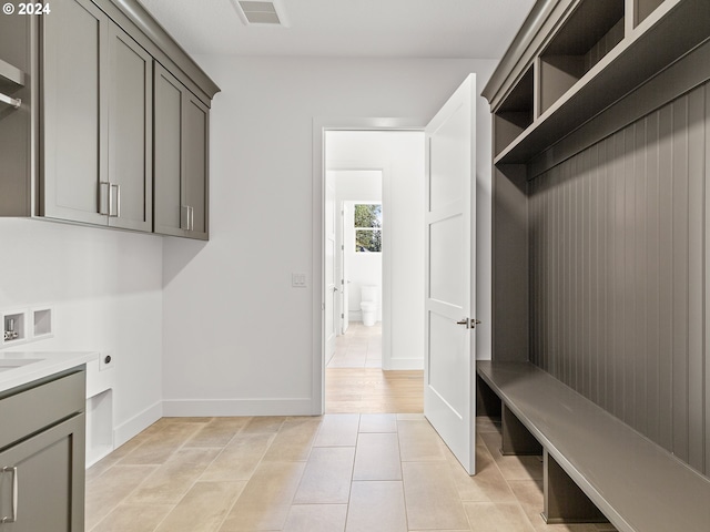 laundry area featuring washer hookup, hookup for an electric dryer, cabinets, and light tile patterned flooring