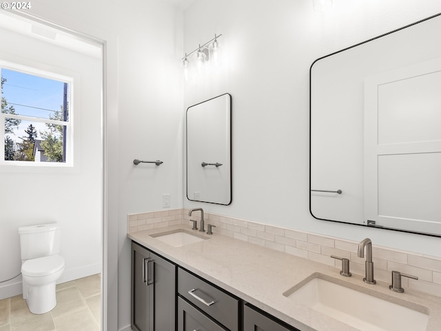 bathroom with tile patterned floors, vanity, and toilet