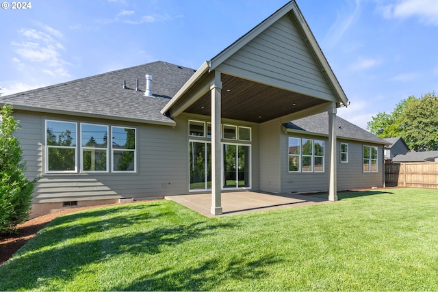 rear view of house featuring a yard and a patio area