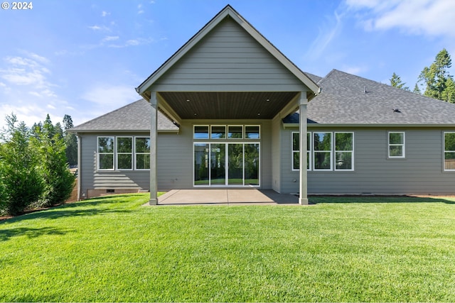 rear view of property featuring a yard and a patio area