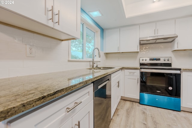 kitchen featuring white cabinets, appliances with stainless steel finishes, light wood-type flooring, and sink