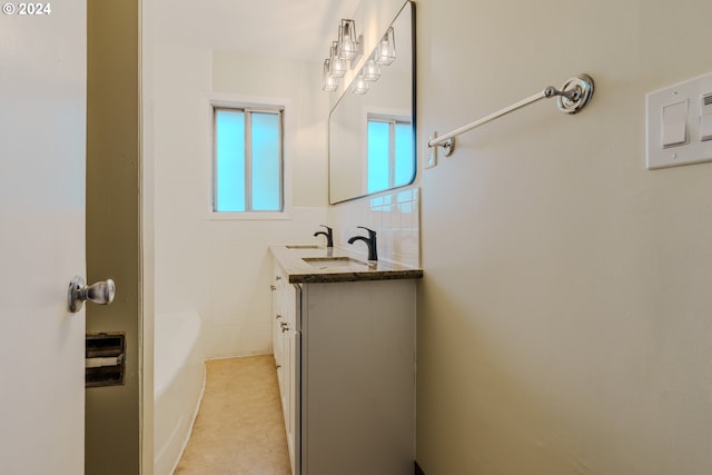 bathroom with vanity, a bathtub, and tile walls