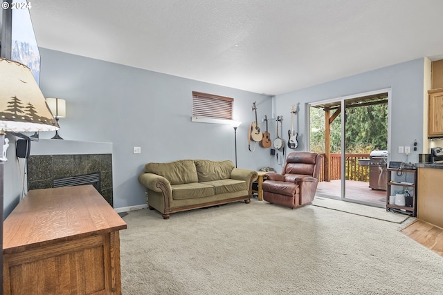 living room with light colored carpet and a tile fireplace