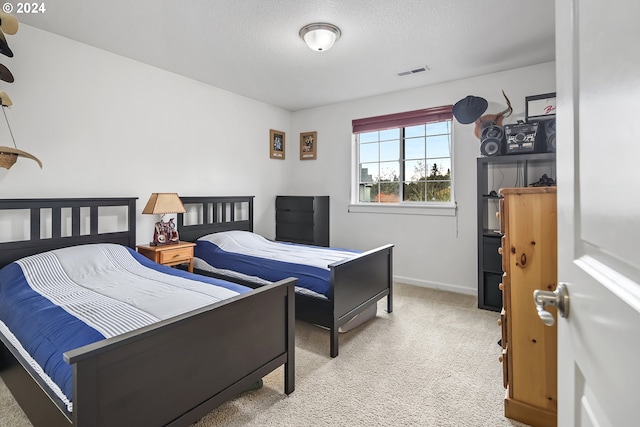 carpeted bedroom with a textured ceiling