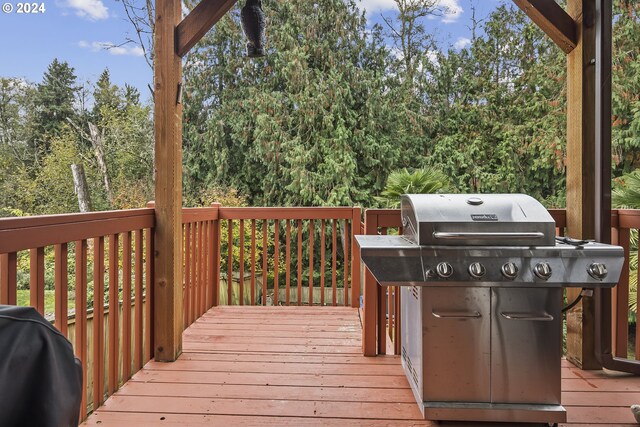 wooden terrace with a grill