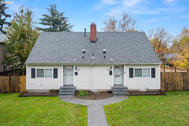 rear view of property with a lawn