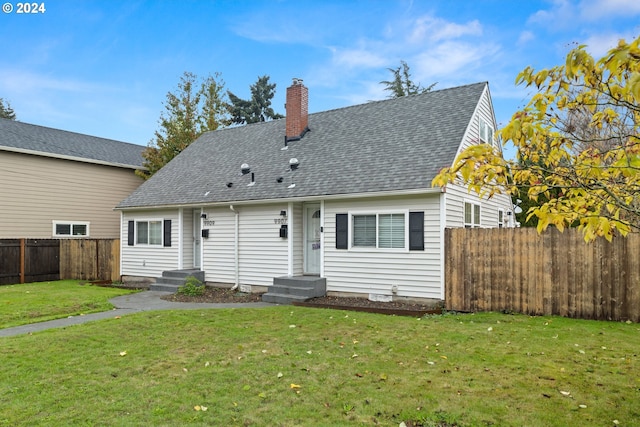 back of house featuring a lawn