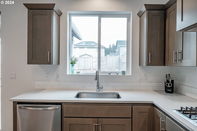 kitchen featuring sink, plenty of natural light, white gas cooktop, and dishwasher