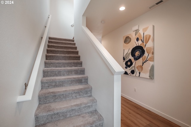 staircase featuring wood-type flooring