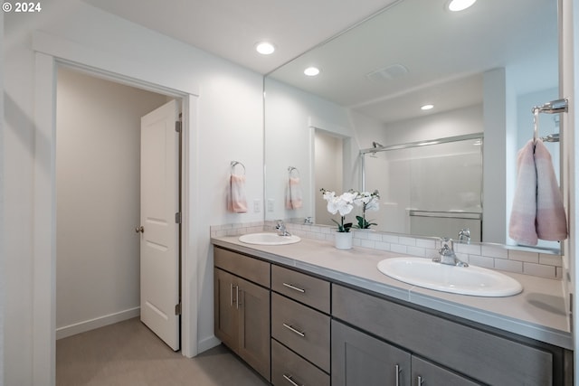 bathroom with walk in shower and vanity