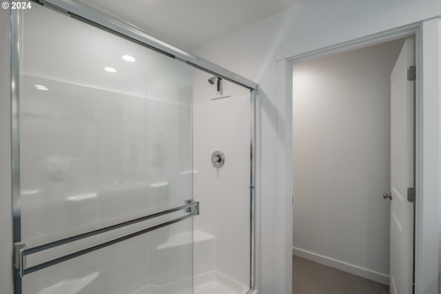 bathroom with a shower with shower door