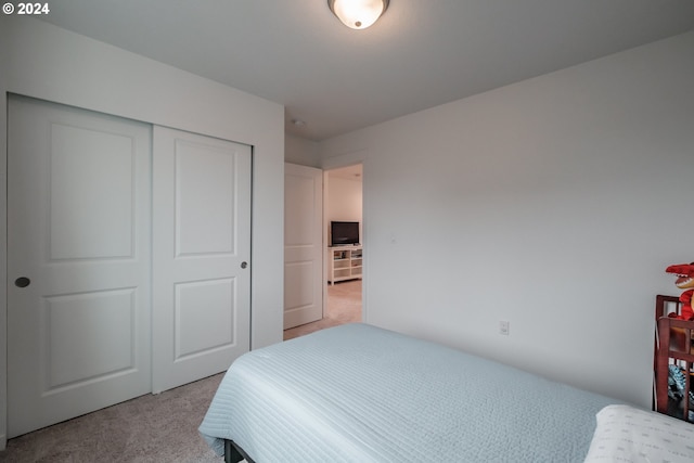 carpeted bedroom with a closet