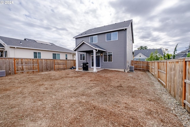 rear view of house with a patio and central air condition unit