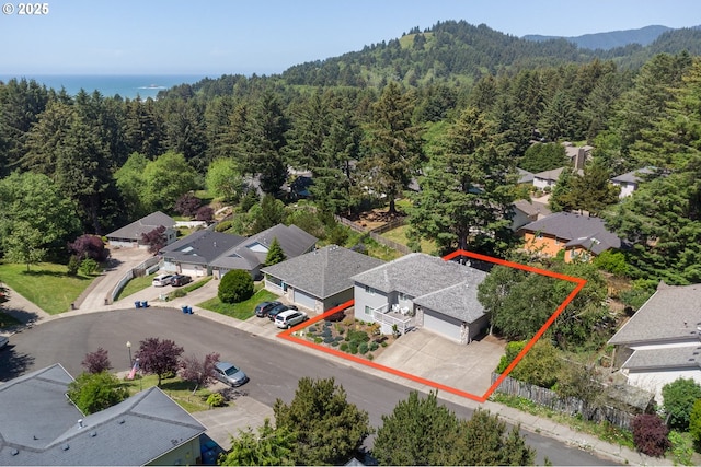 bird's eye view with a residential view, a wooded view, and a water view