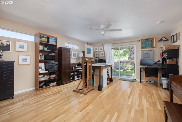 office featuring baseboards, light wood-style floors, and a ceiling fan