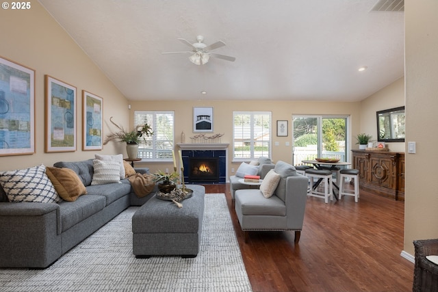 living room featuring visible vents, ceiling fan, dark wood finished floors, and vaulted ceiling