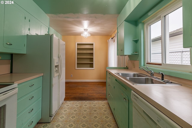 kitchen with sink, light hardwood / wood-style floors, white appliances, and an inviting chandelier