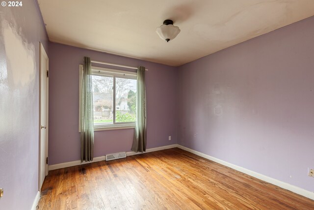 empty room with wood-type flooring