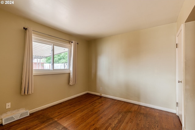 spare room featuring dark wood-type flooring