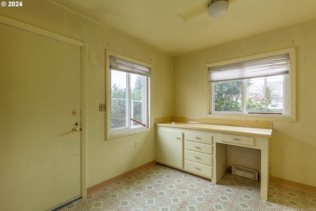 interior space with a wealth of natural light and built in desk