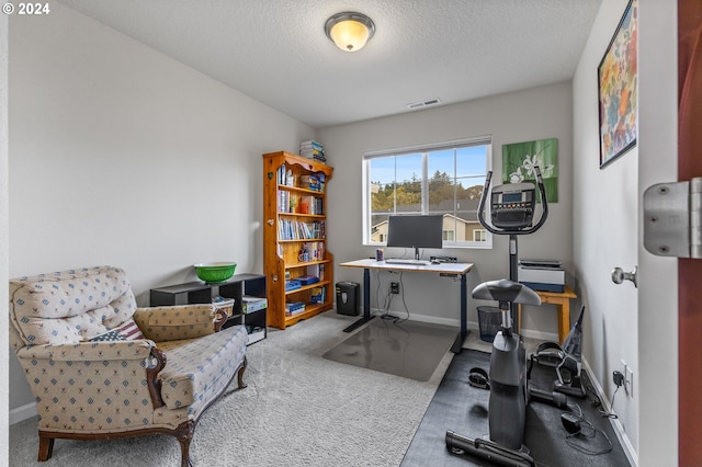 office area with a textured ceiling and carpet floors