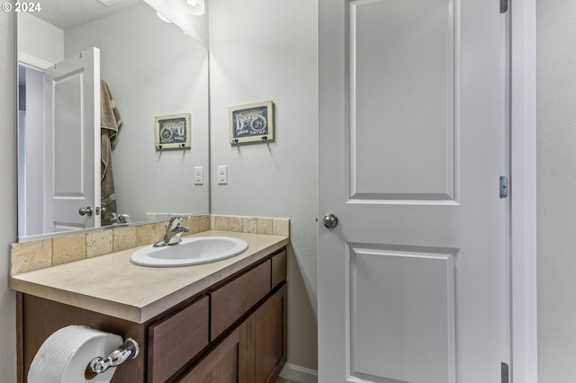 bathroom with vanity and a textured ceiling