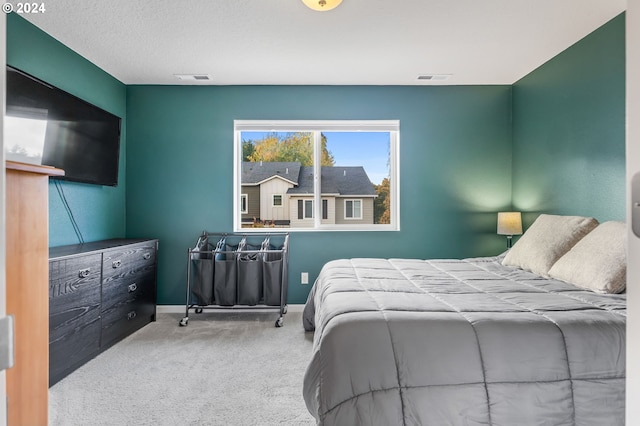 carpeted bedroom with a textured ceiling