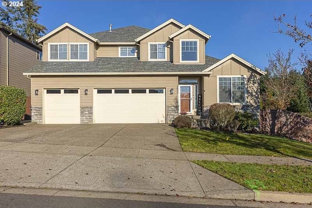 view of front of property with a front yard and a garage