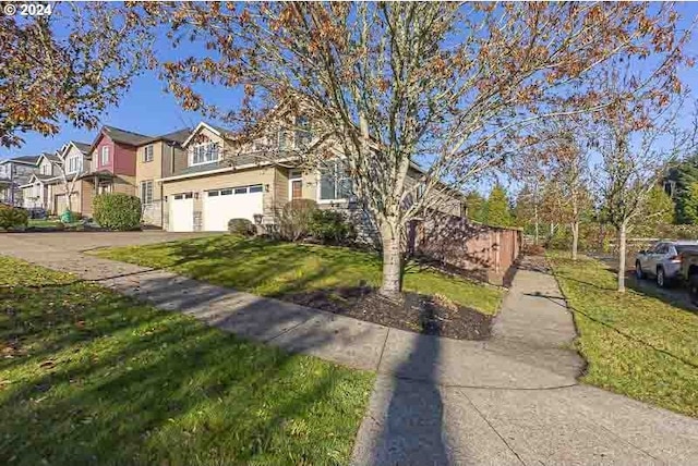 view of front of property featuring a front lawn and a garage